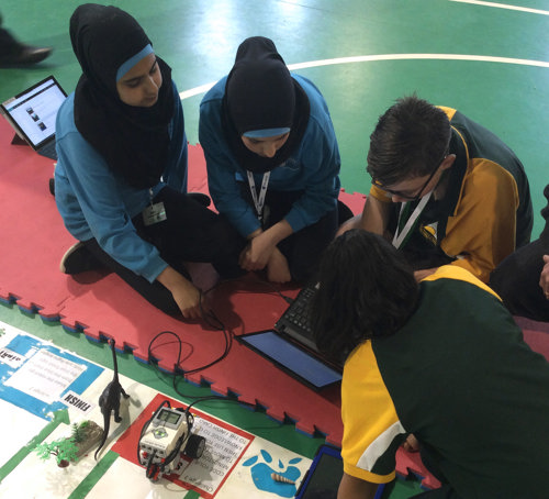 Image of students with a laptop