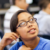 A girl with glasses looking up