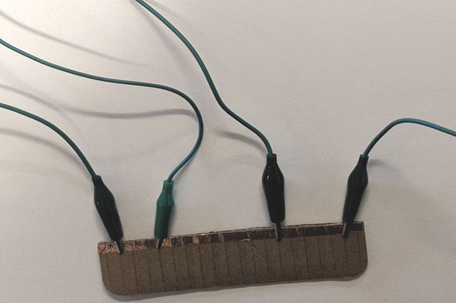 Single Conductive Rail: Image of alligator clips connected to a metal tape
